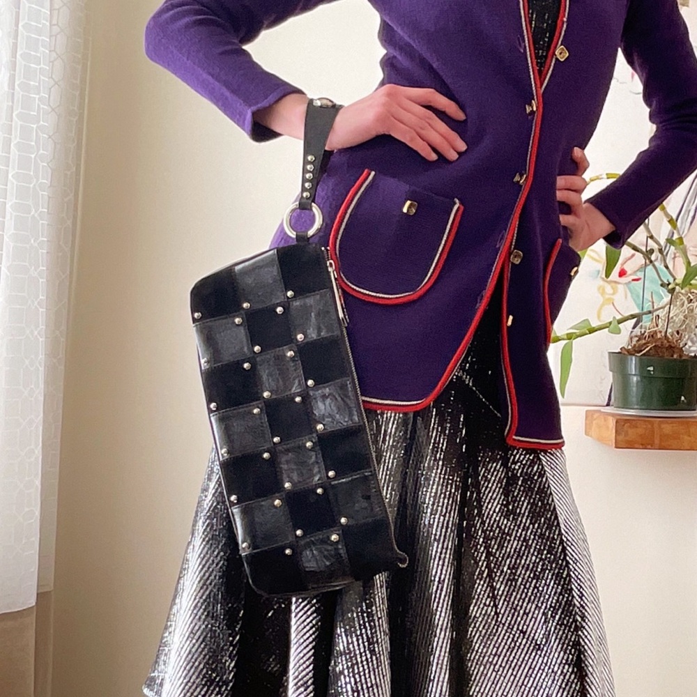 Black leather and suede checkerboard clutch with studs and wrist strap